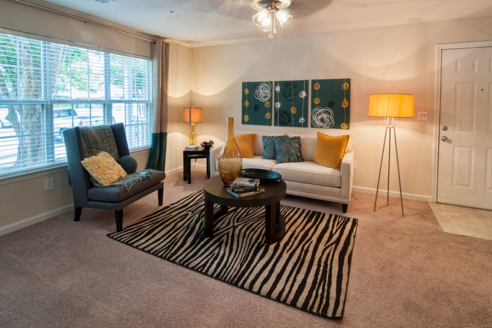 Living room interior decorate it with modern furnishings window to allow lots of natural light in an apartment at Bellingham Apartment Homes in Marietta, Georgia
