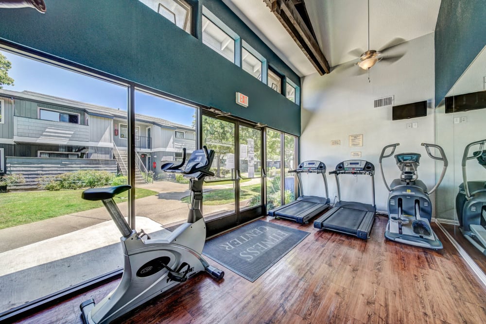 Fitness center with plenty of individual workout stations at Parkside Commons Apartments in San Leandro, California