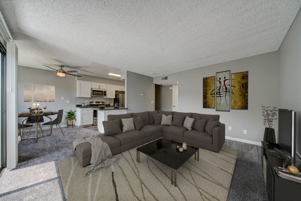 A dining room, kitchen and living room at Parkside Commons Apartments in San Leandro, California