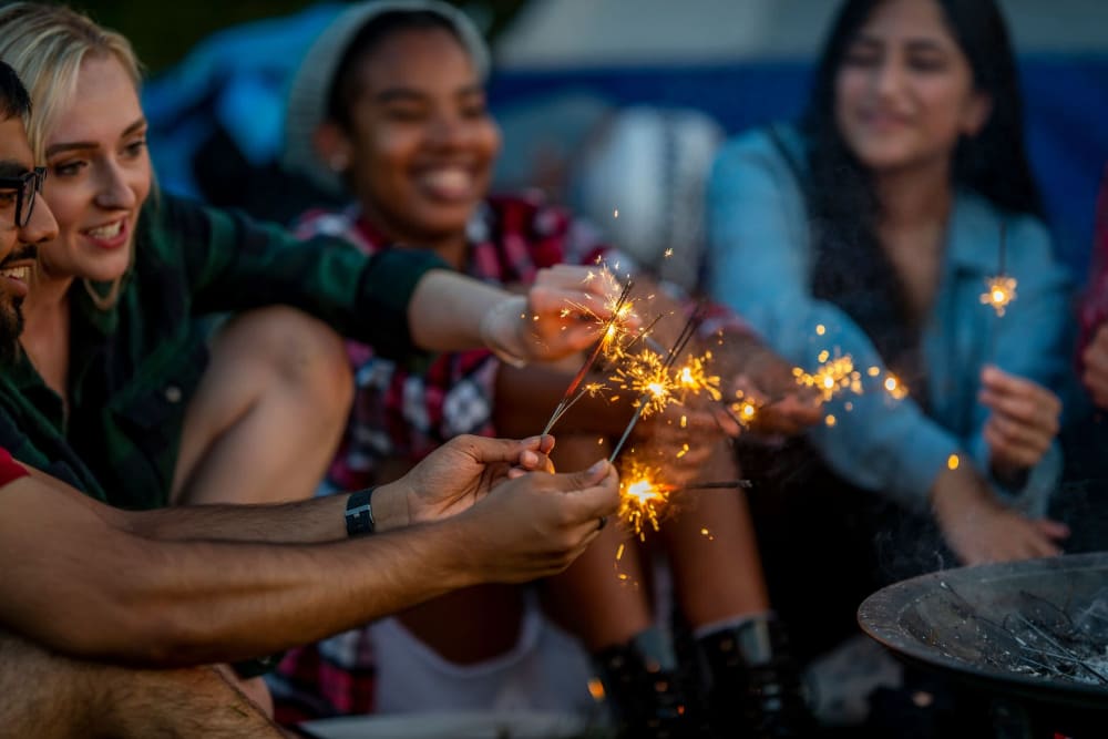 Friends lighting off sparklers near UNCOMMON Fort Collins in Fort Collins, Colorado