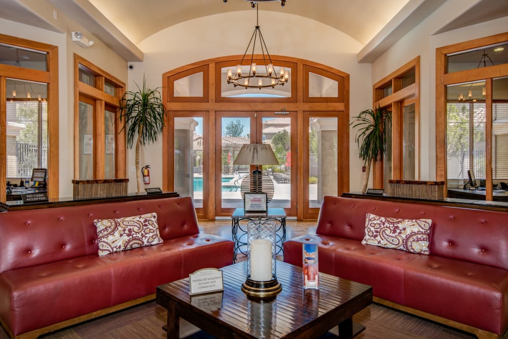 Clubhouse interior at Broadstone Towne Center in Albuquerque, New Mexico features red leather couches and other fine furnishings