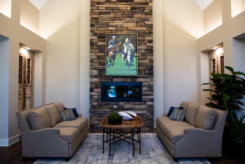 Fireplace lounge with sofas and chairs for visiting at Westminster Memory Care in Aiken, South Carolina