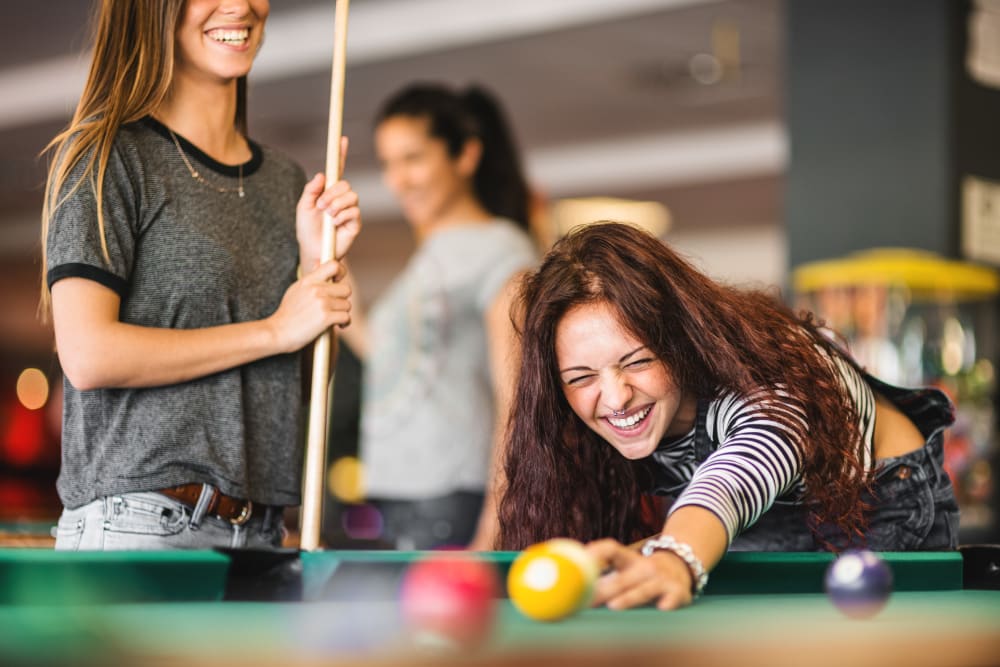 Residents playing billiards in Bloomington, Indiana near evolve Bloomington