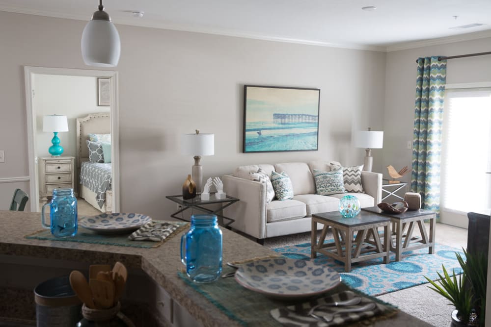 Living room with plush carpeting and patio access at Ansley Commons Apartment Homes in Ladson, South Carolina