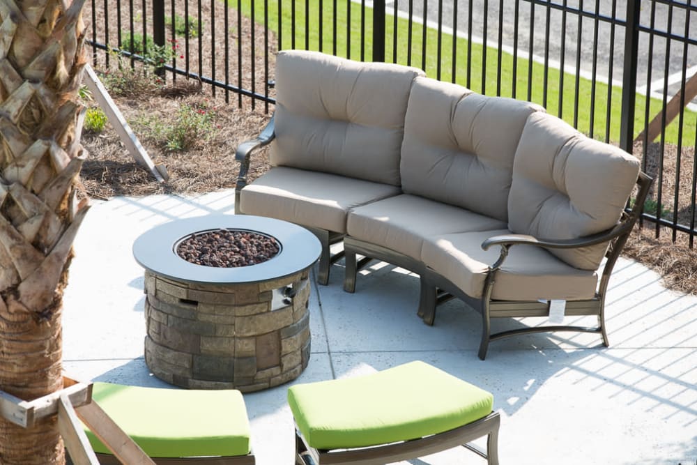 Comfortable seating around a fire pit at Ansley Commons Apartment Homes in Ladson, South Carolina