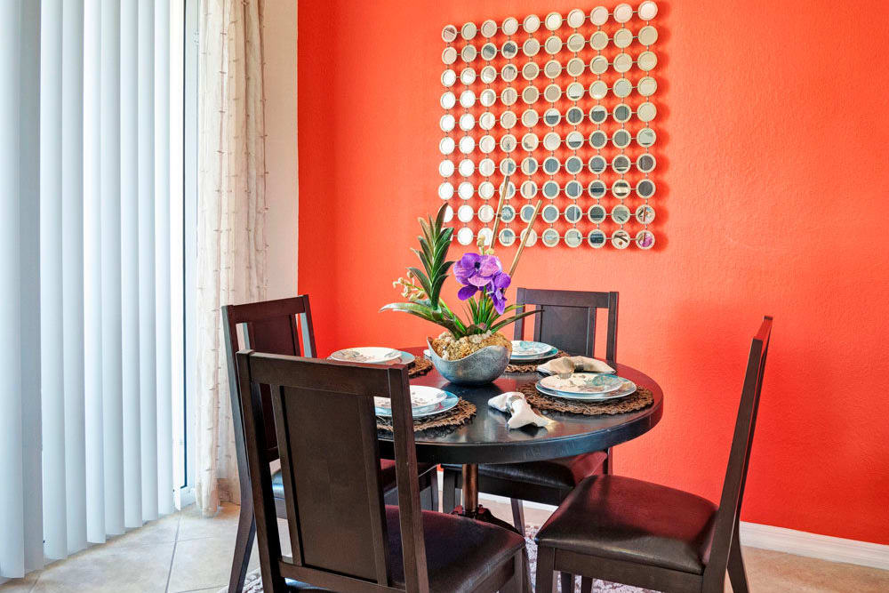 Brightly painted wall in dining room area in an apartment at City Center on 7th Apartment Homes in Pembroke Pines, Florida