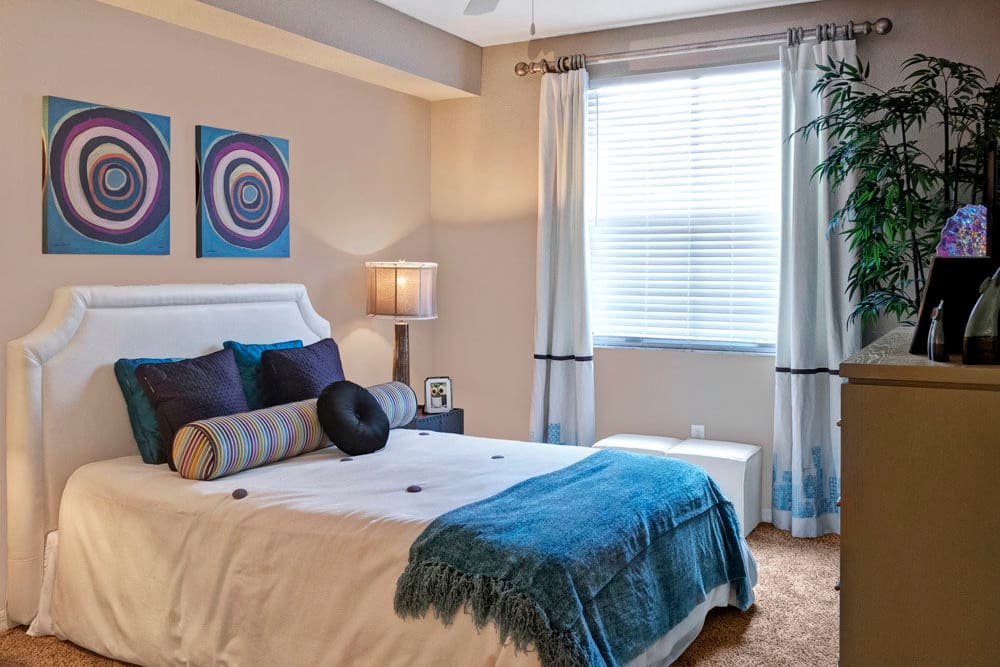 Comfortable bedroom featuring large window for ample natural light at City Center on 7th Apartment Homes in Pembroke Pines, Florida