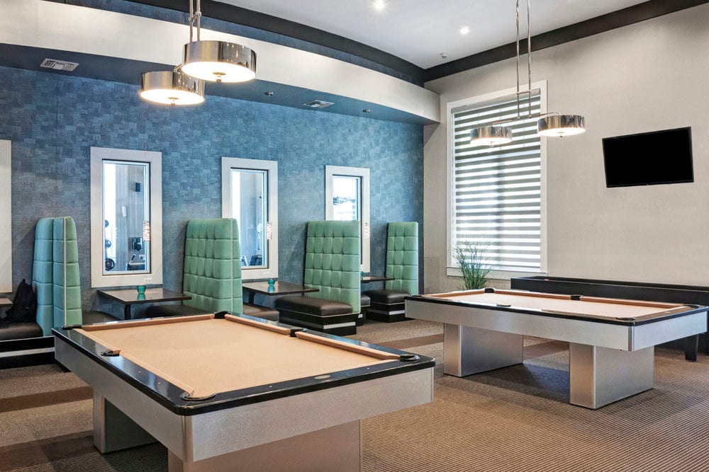 Billiards table and shuffleboard and clubhouse at City Center on 7th Apartment Homes in Pembroke Pines, Florida