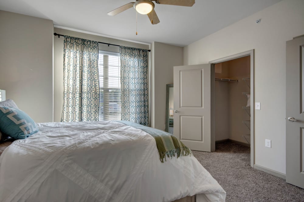 Bedroom with spacious closet and large windows for natural light in an apartment at Creekside South in Wylie, Texas