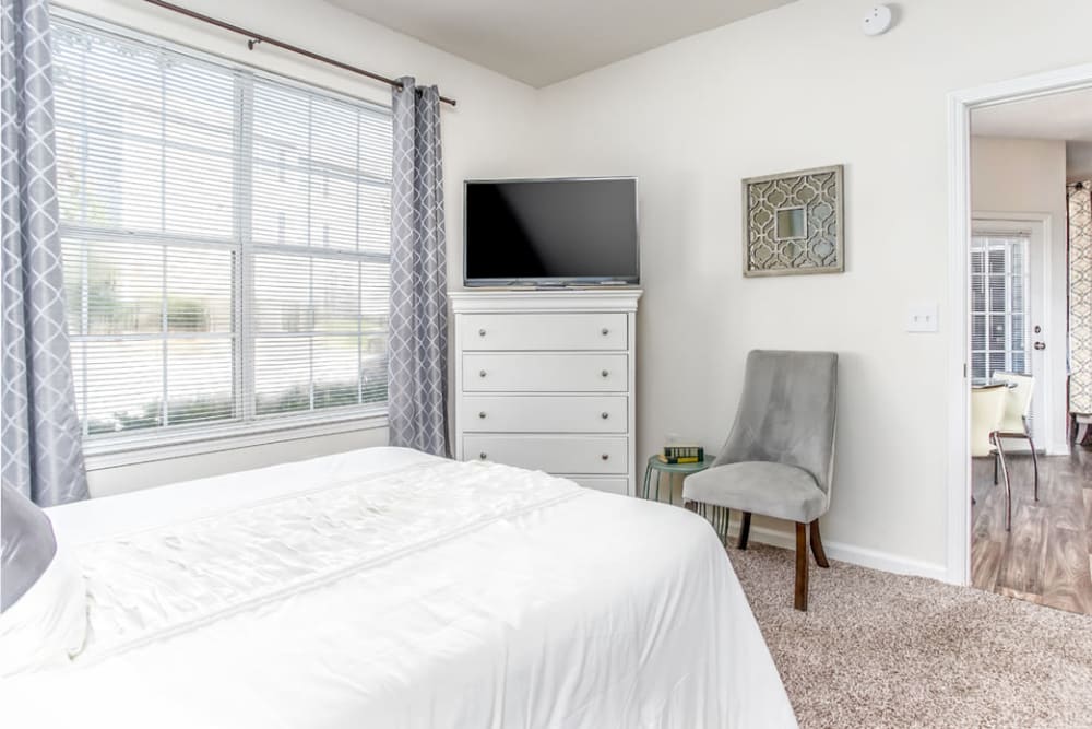 Large windows offer a Naturally light and bright bedroom space at Eastwood Village in Stockbridge, Georgia