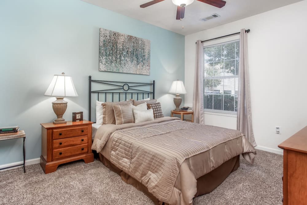 Bedroom at Eastwood Village in Stockbridge, Georgia features a blue-green accent wall