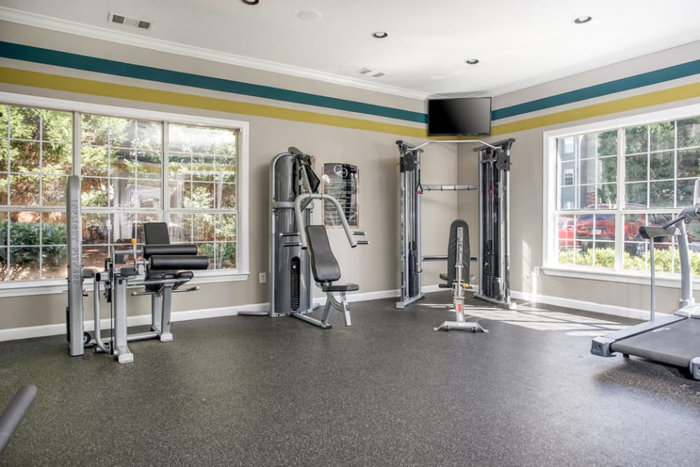 Spacious fitness room with lots of natural light from large windows at Eastwood Village in Stockbridge, Georgia