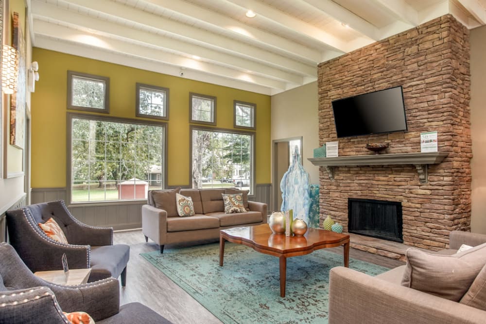 Clubhouse interior featuring a fireplace and comfortable sitting area at Eastwood Village in Stockbridge, Georgia
