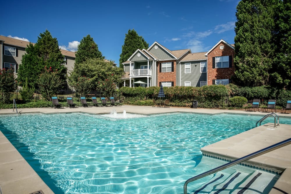 Outdoor community pool with apartments in the background at Eastwood Village in Stockbridge, Georgia