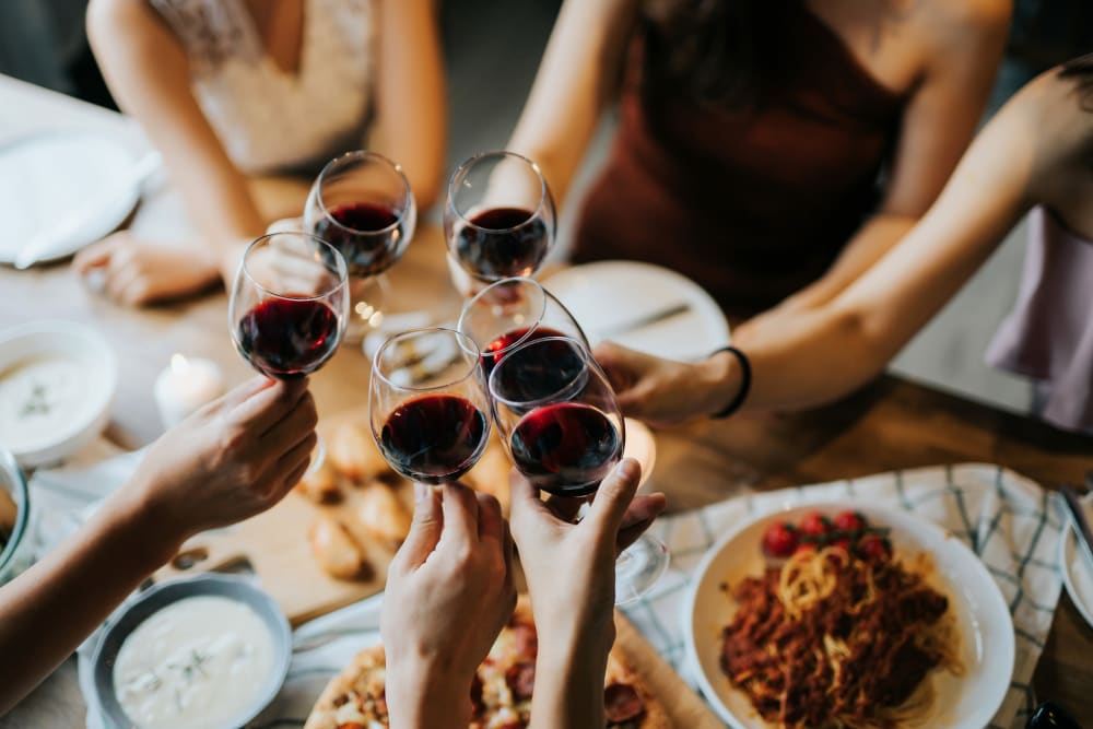 Resident friends raising a toast at a nearby restaurant to the good life at Alturas Embry Hills in Doraville, Georgia