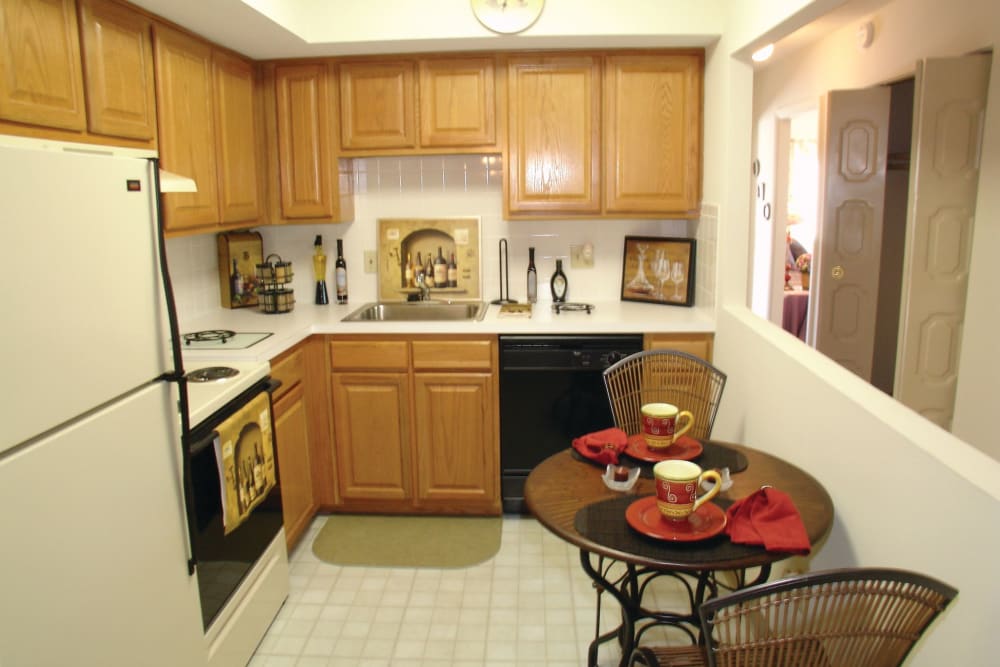View of the kitchen with open space in wall by table in an apartment at The Heights At Marlborough in Marlborough, Massachusetts