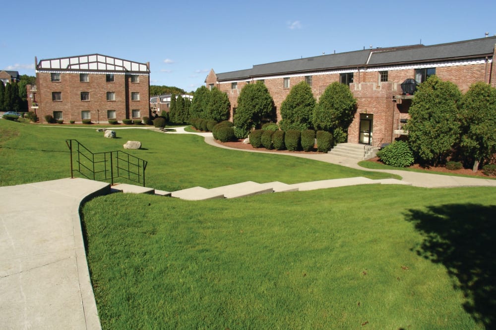 Walkways and grassy field outside of apartment buildings at The Heights At Marlborough in Marlborough, Massachusetts