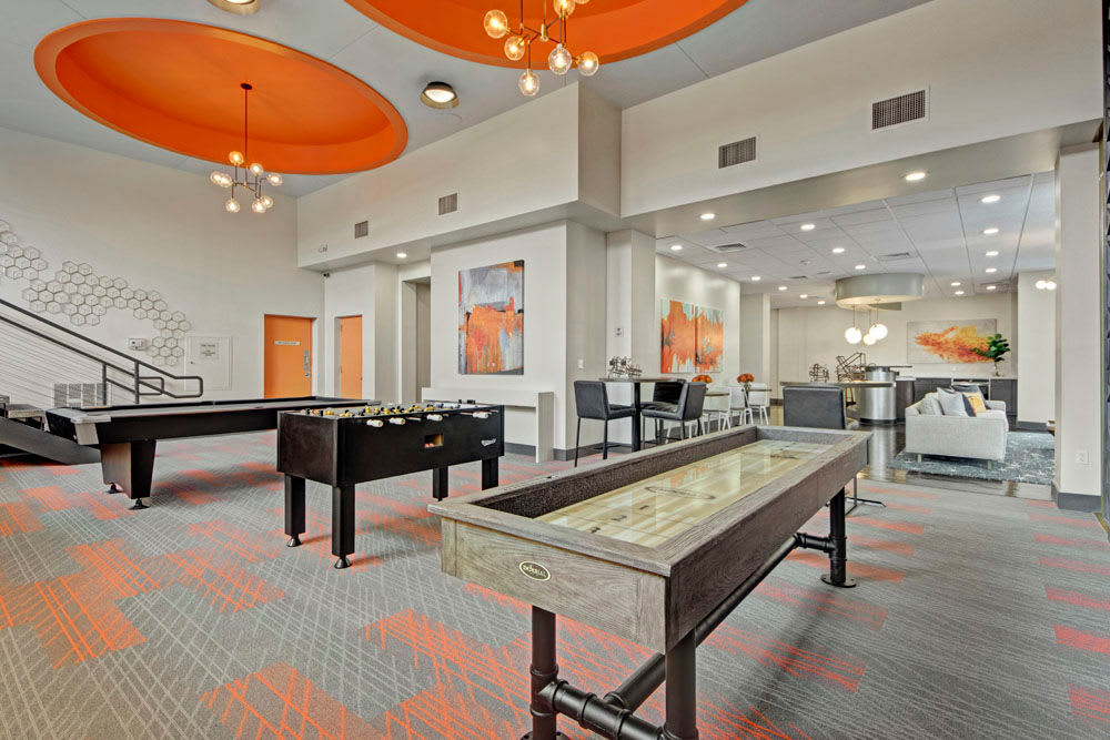 Pool table, shuffleboard, and other amenities in the clubhouse at Manor House in Dallas, Texas