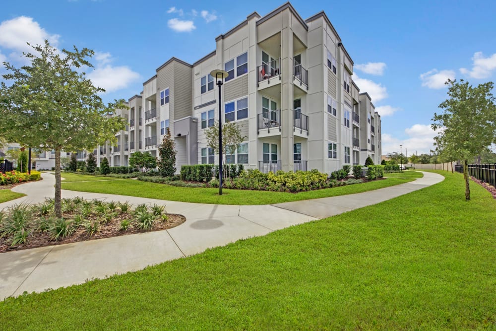 Apartment building with well manicured grounds at Linden on the GreeneWay in Orlando, Florida