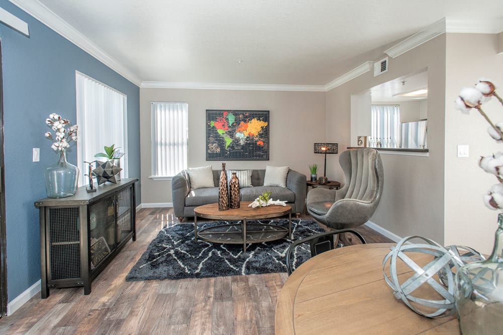 Living room with wood-style flooring and back patio access at Sandpiper Village Apartment Homes in Vacaville, California