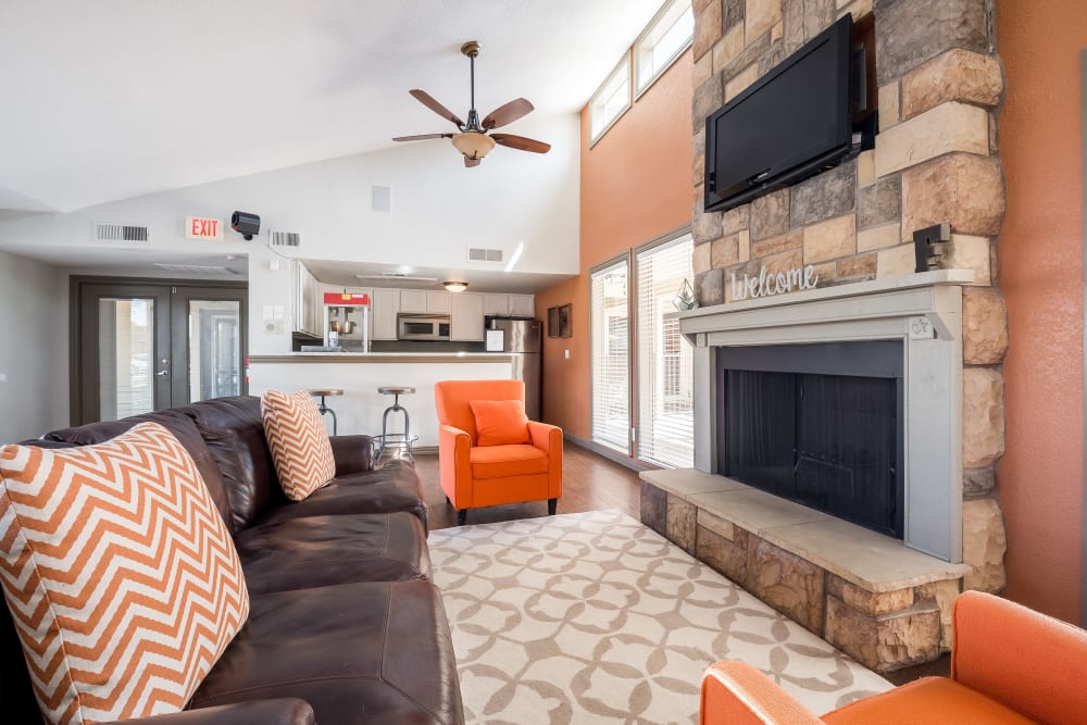 Well decorated clubhouse interior with bar and fireplace at The Fairway Apartments in Plano, Texas