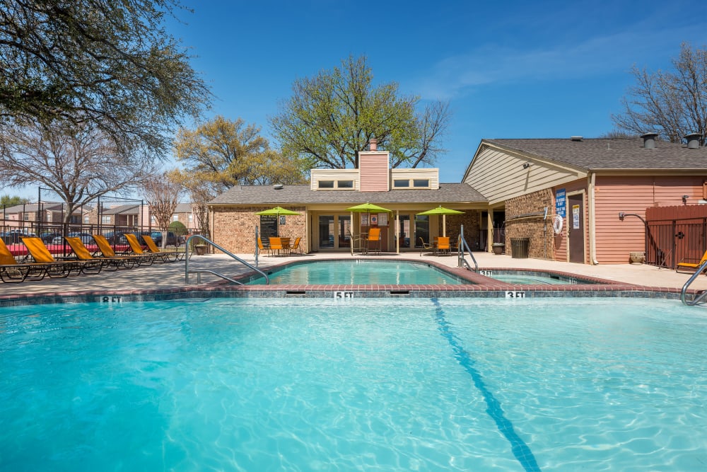 Two pools and a hot tub outside at The Fairway Apartments in Plano, Texas