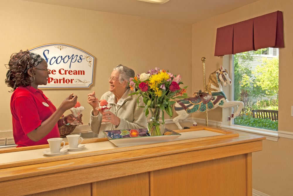 A resident and staff member eating ice cream at Patriots Glen in Bellevue, Washington. 