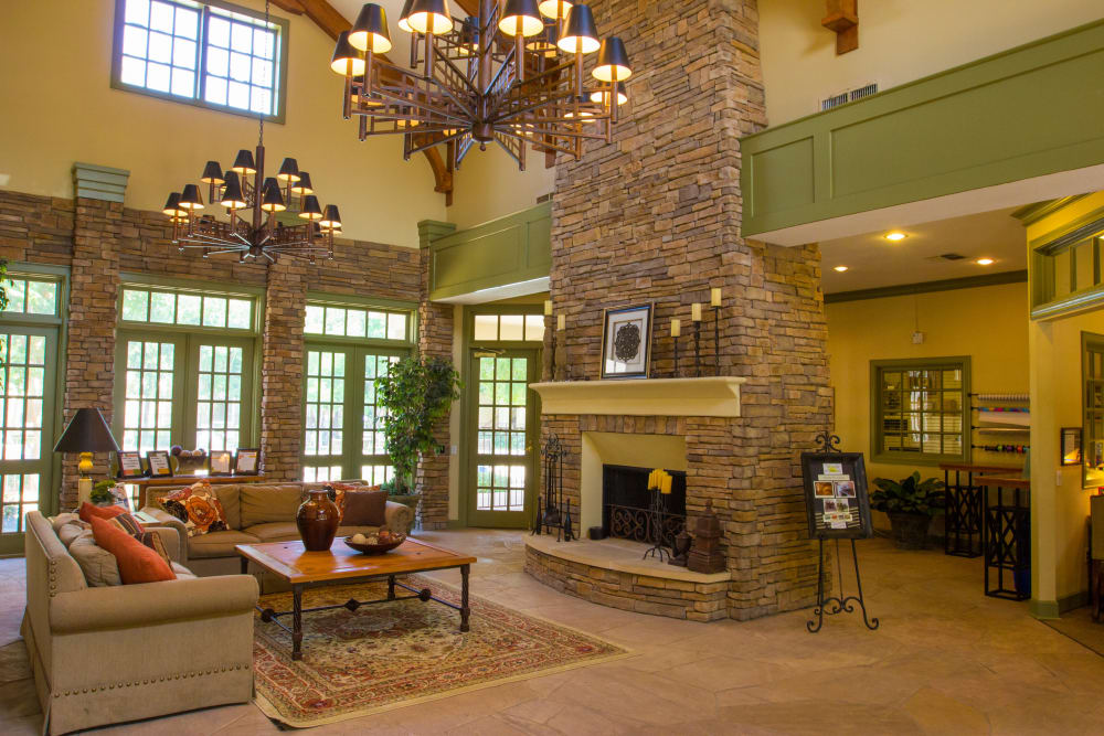 Clubhouse for residents with brick interior and fireplace at The Lodge at River Park in Fort Worth, Texas
