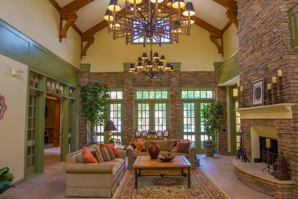 Clubhouse for residents with brick interior and fireplace at The Lodge at River Park in Fort Worth, Texas