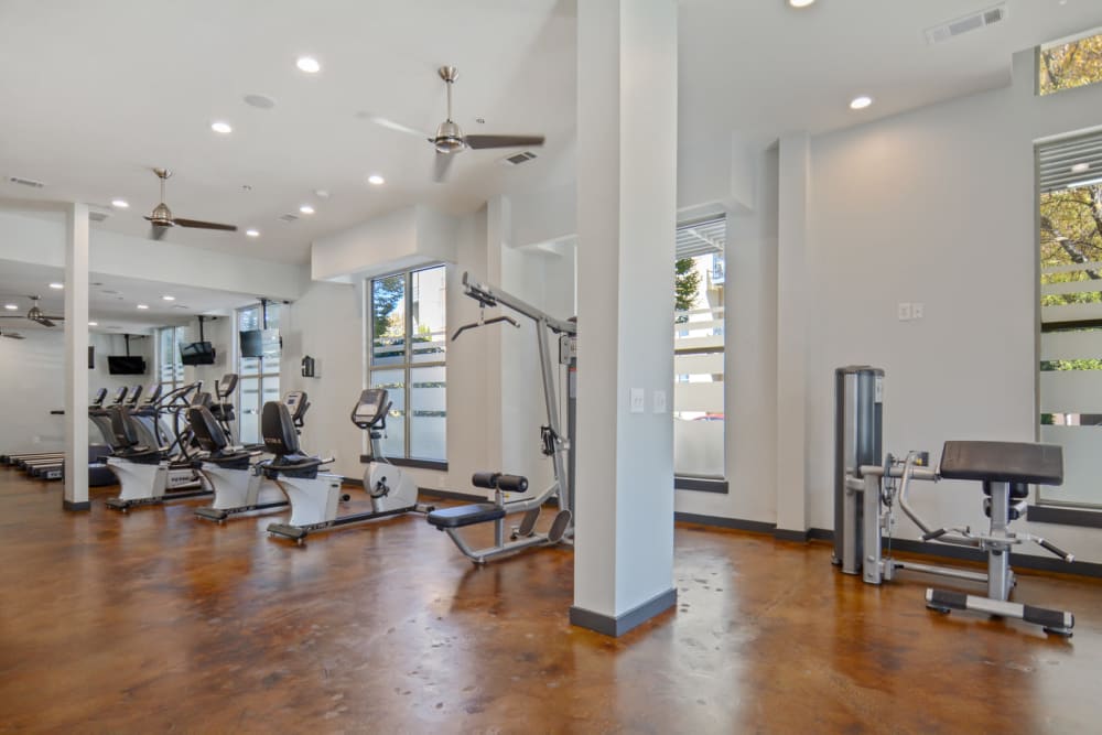 High ceilings and ample exercise equipment at the onsite fitness center at Ellington Midtown in Atlanta, Georgia