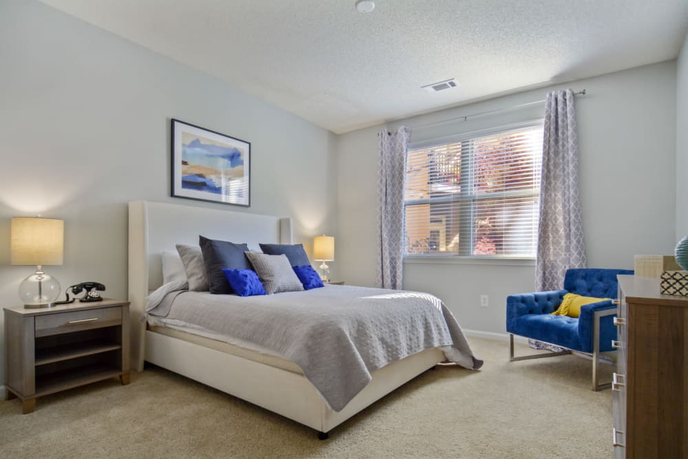 Plush carpeting and a large bay window in a model home's bedroom at Ellington Midtown in Atlanta, Georgia