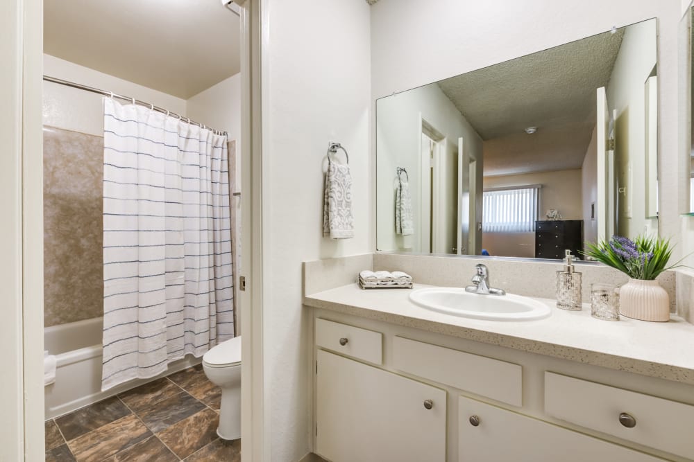 Bright bathroom with separate toilet and bathtub area at The Crossroads, in Van Nuys, CA