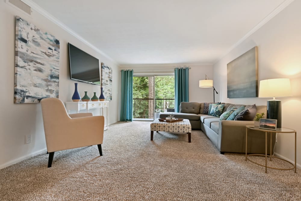 Modern decor and plush carpeting in a model home's living area at Crest at Riverside in Roswell, Georgia