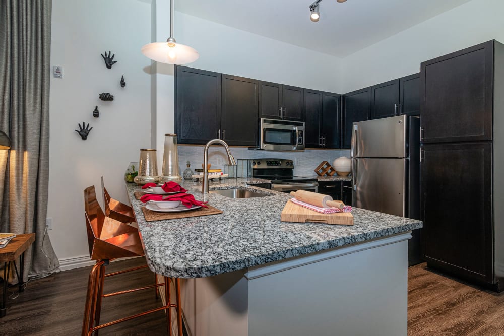 Granite countertops in a model home's kitchen at Twin Creeks Crossing in Allen, Texas