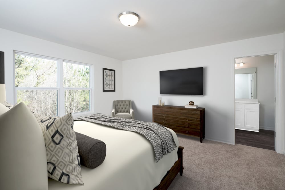 A rendering of a bedroom layout with television at Artisan Living Bella Citta in Davenport, Florida