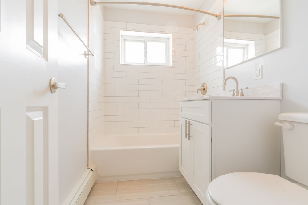 Bright, clean bathroom at Eagle Rock Apartments at Carle Place in Carle Place, New York
