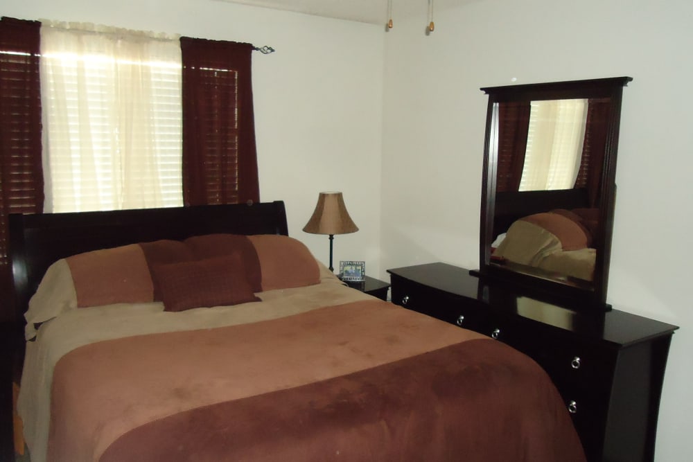 Cozy bedroom at Olympus Court Apartments in Bakersfield, California