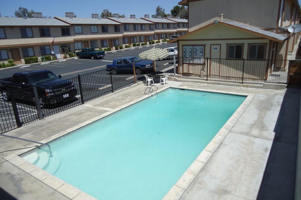 Clean blue swimming pool at Olympus Court Apartments in Bakersfield, California