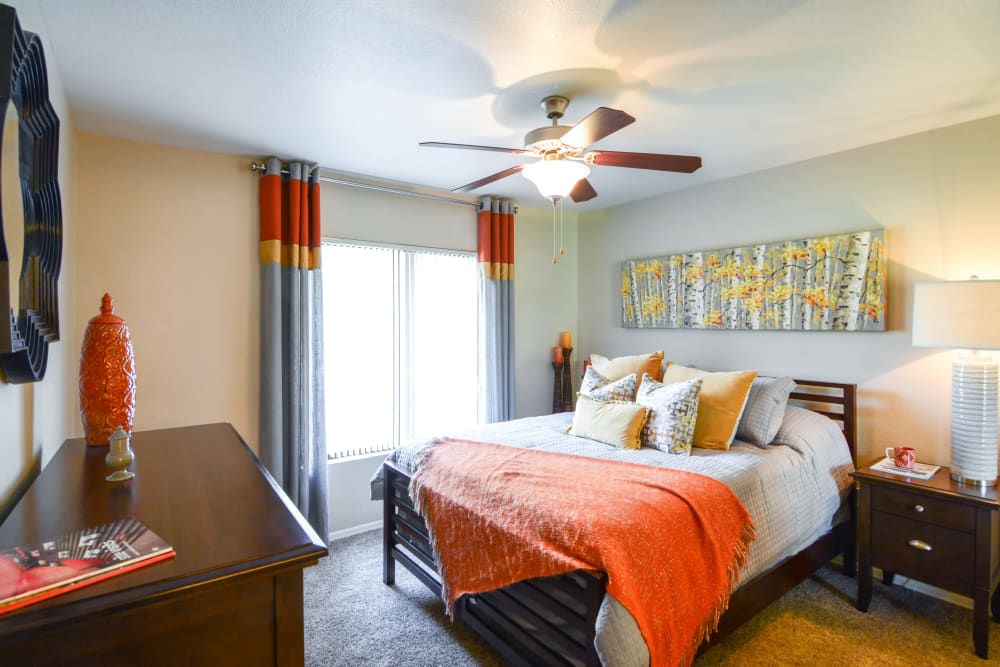 Bright bedroom with orange accents at The Palms on Scottsdale in Tempe, Arizona