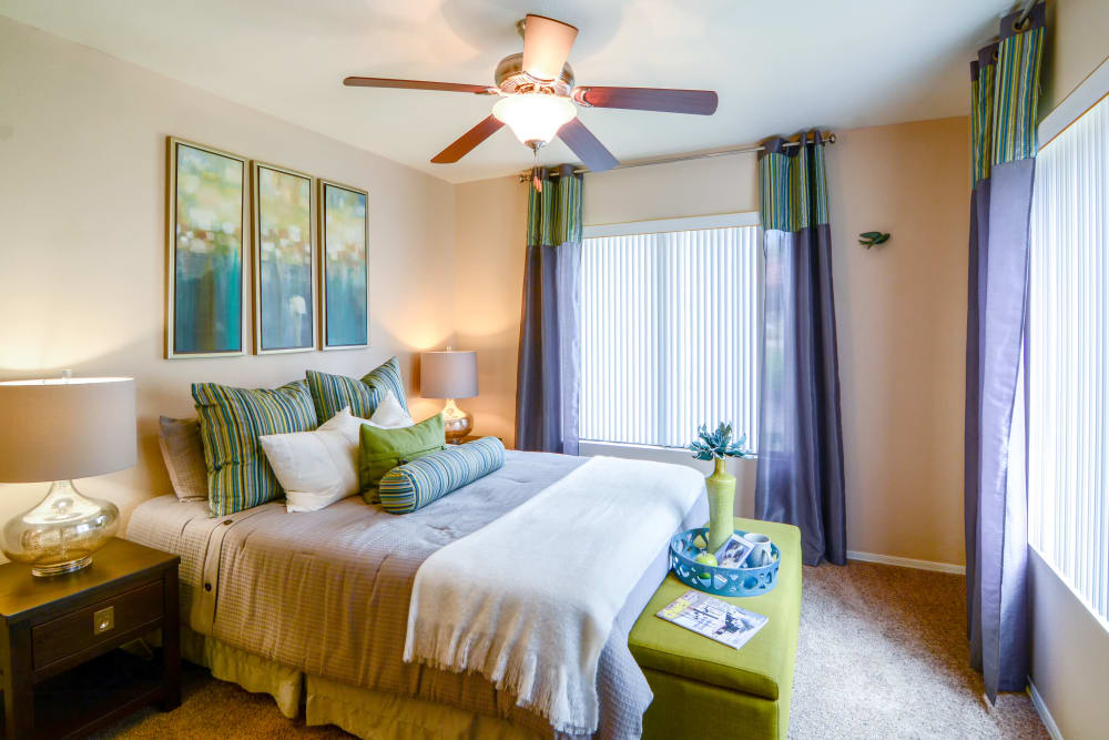 Bedroom with green accents at The Palms on Scottsdale in Tempe, Arizona