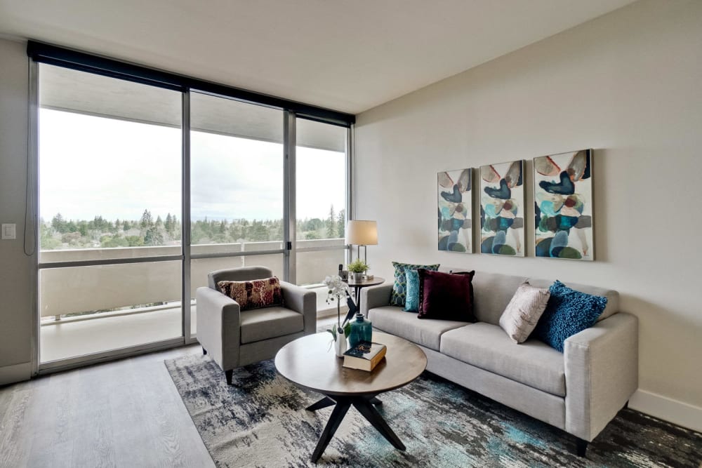 Apartments with a luxury living room with sliding glass door to private balcony at The Marc, Palo Alto