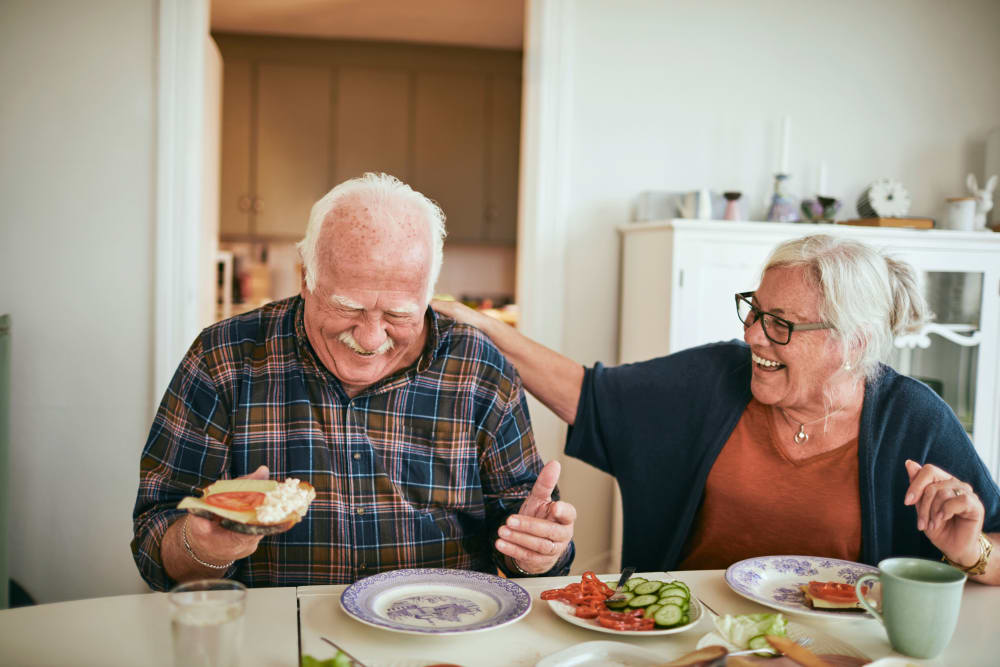 Resident couple eating at a table in their apartment at Edencrest at Tuscany in Altoona, Iowa