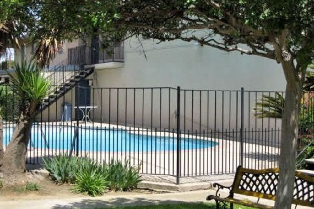 View of the pool through the gate at Highland View Court in Bakersfield, California