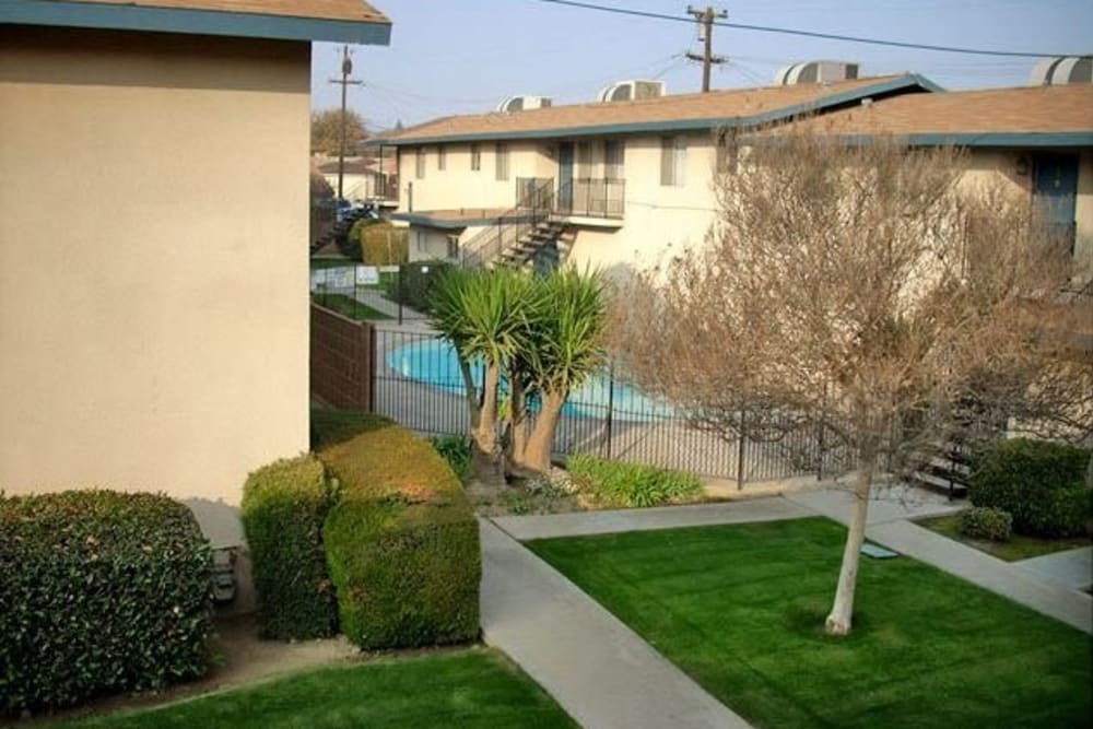 Impeccable landscape with a view of the pool at Highland View Court in Bakersfield, California