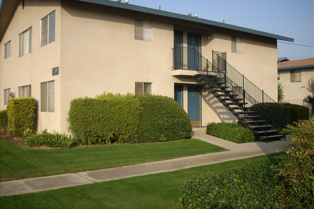 Exterior view of stairwell and impeccable landscape at Highland View Court in Bakersfield, California