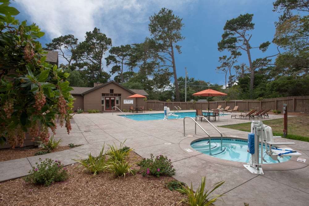 Relaxing swimming pool and hot tub outside at Seventeen Mile Drive Village Apartment Homes in Pacific Grove, California