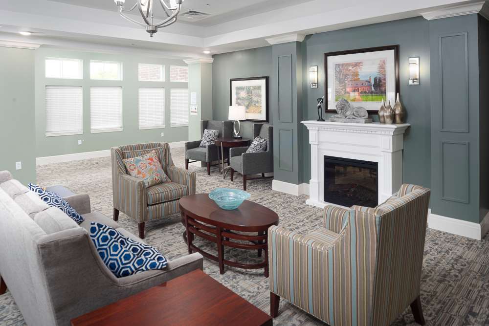 Living room with carpet flooring and fireplace at Harmony at Spring Hill in Lorton,Virginia