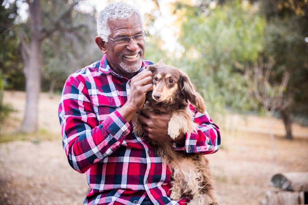 A resident with his dog at a Merrill Gardens community.