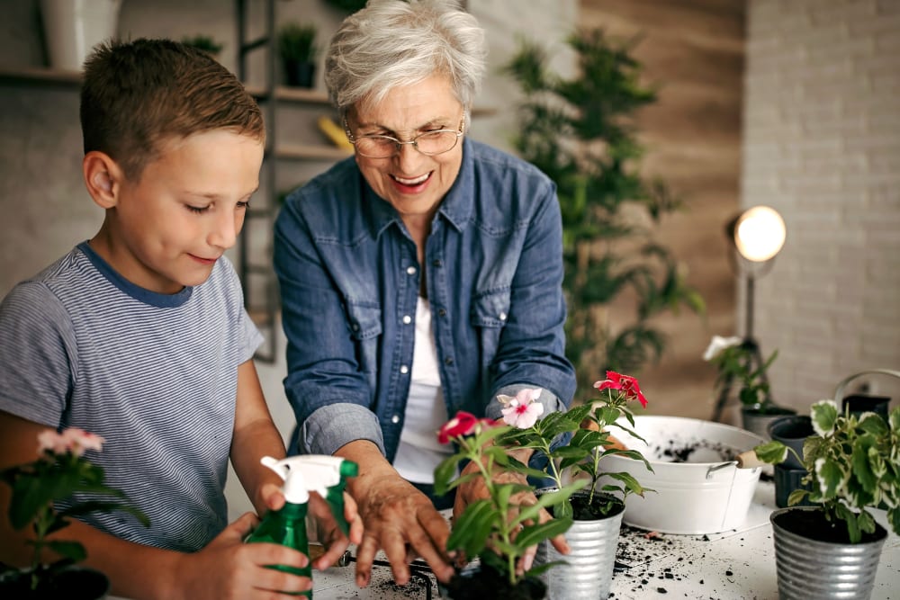 A resident and her grandchild gardening at Merrill Gardens. 