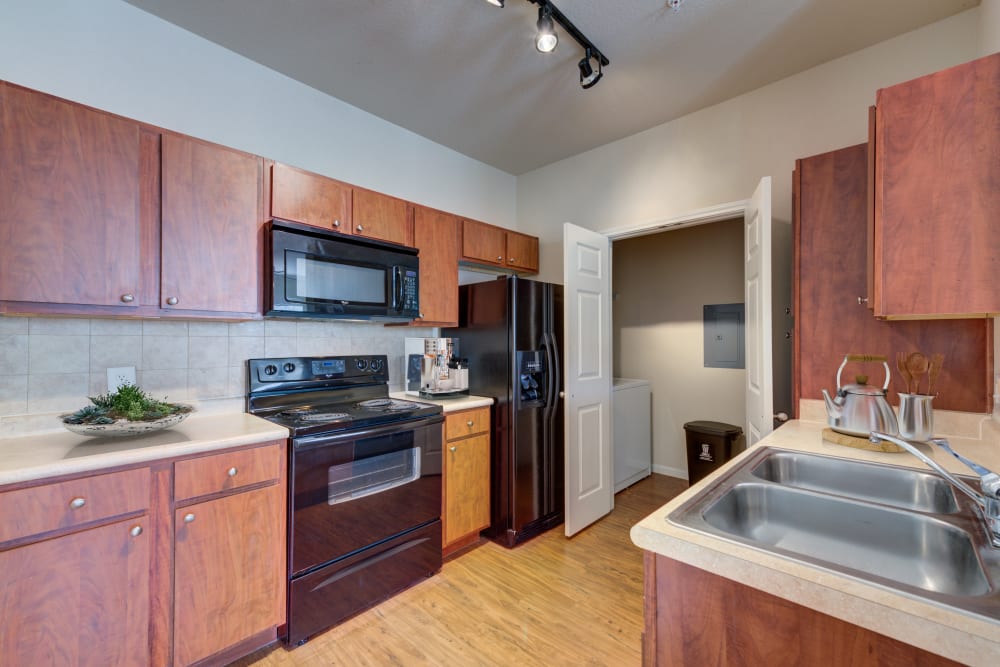 Modern and bright kitchen with separate laundry closet at Ingleside Apartments in North Charleston, South Carolina
